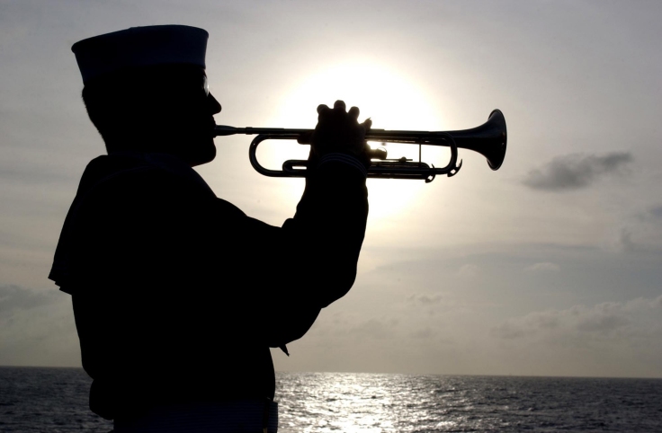US_Navy_030415-N-5555F-075_Machinist_Mate_3rd_Class_Brian_Walker_plays_TAPS_on_his_trumpet_during_a_Burial_at_Sea_on_the_fast_combat_support_ship_USS_Sacramento_(AOE_1).jpg